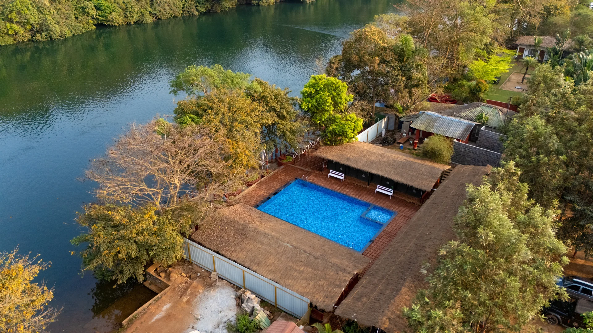 Riverside pool and cottages at Nadi Teera, Dandeli