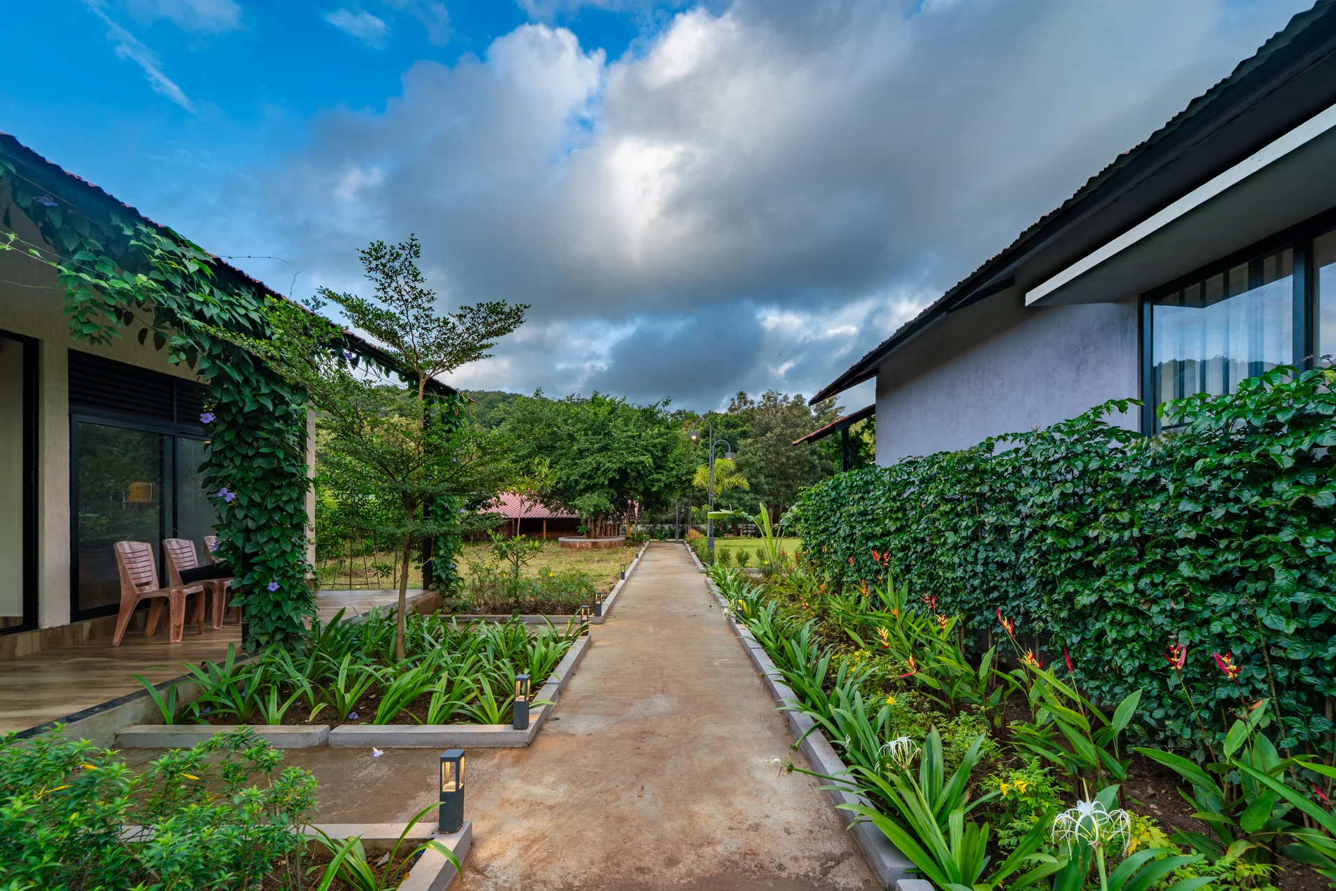 A garden path between the cottages at Nadi Teera, Dandeli