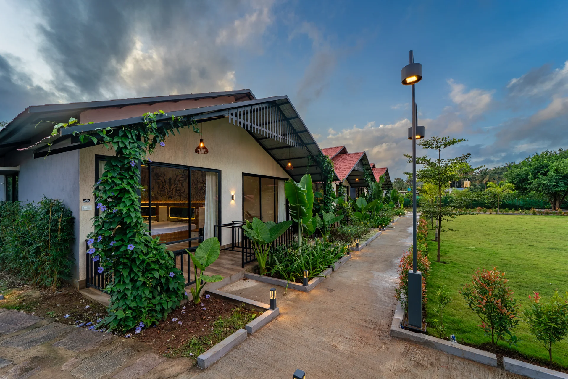 Garden cottage and walking path at Nadi Teera, Dandeli