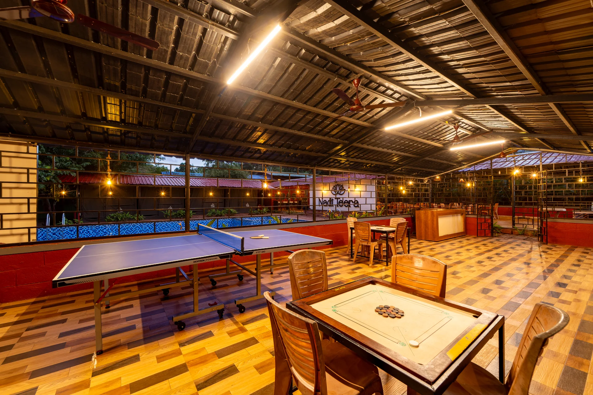Carrom in the poolside dining area at Nadi Teera, Dandeli