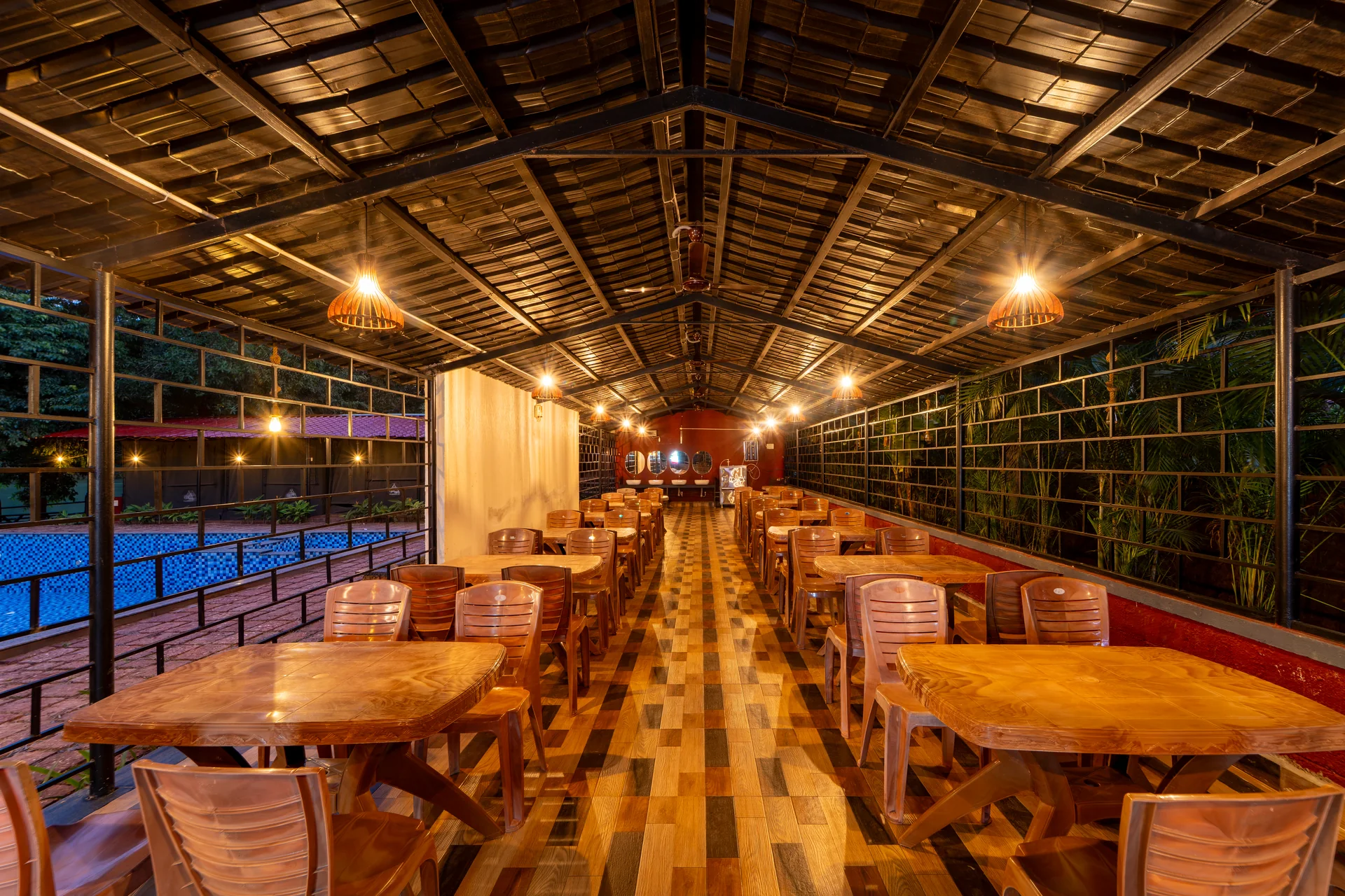Tables in the open-air dining hall at Nadi Teera, Dandeli