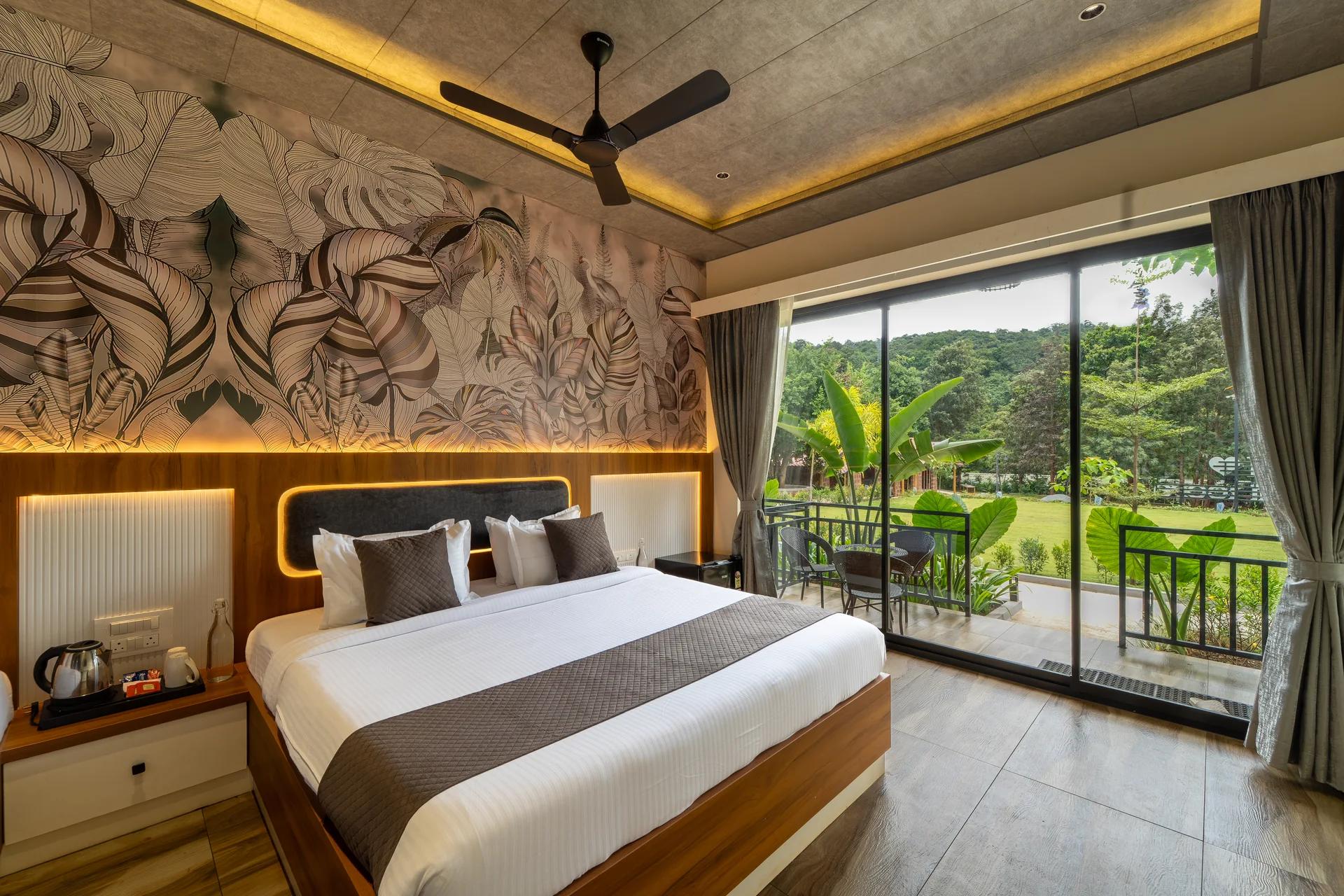 Premium Cottage bed beside the balcony at Nadi Teera, Dandeli