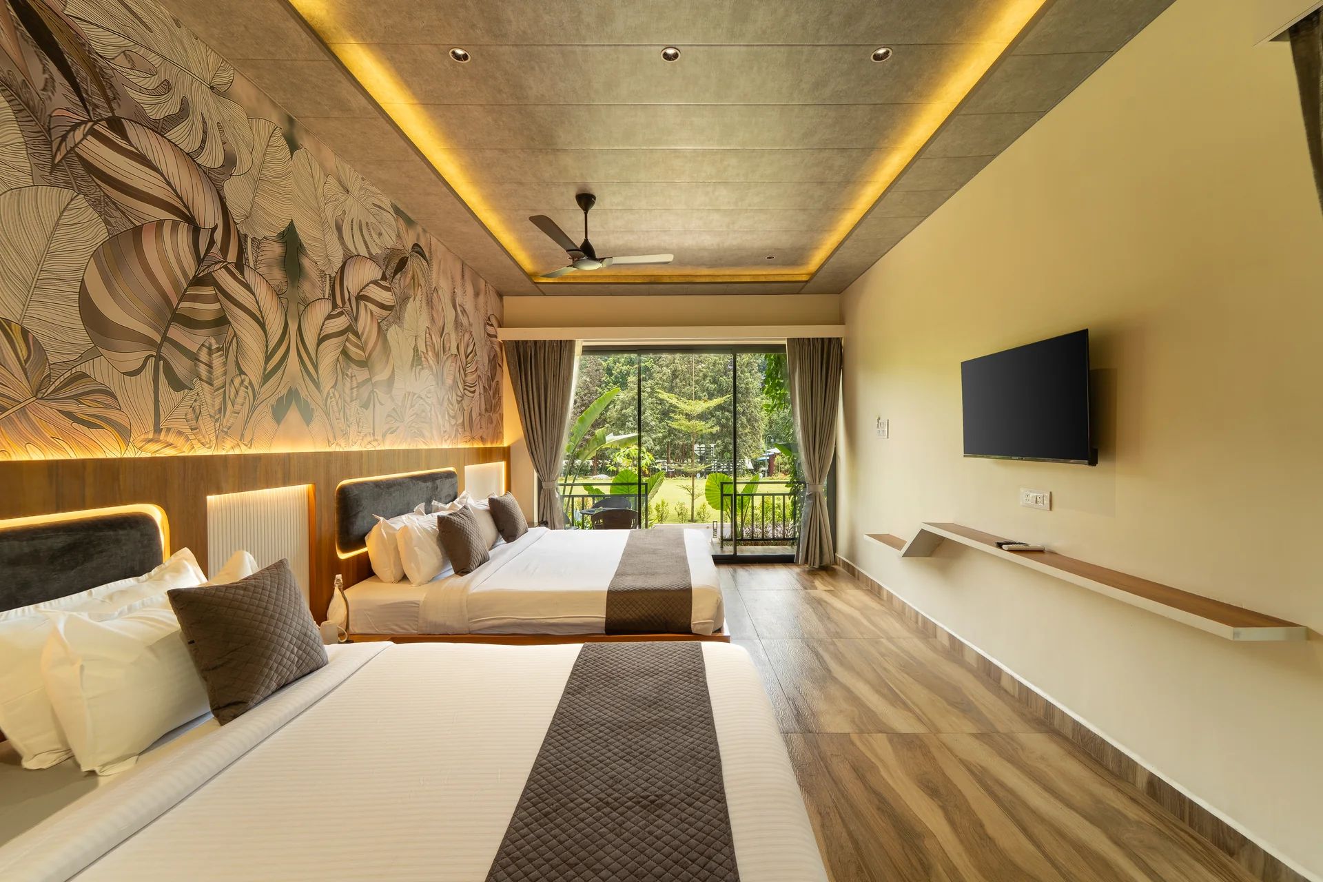 Premium Cottage bedroom and television at Nadi Teera, Dandeli